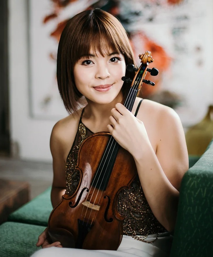 Jiyoon Lee with violin on green couch