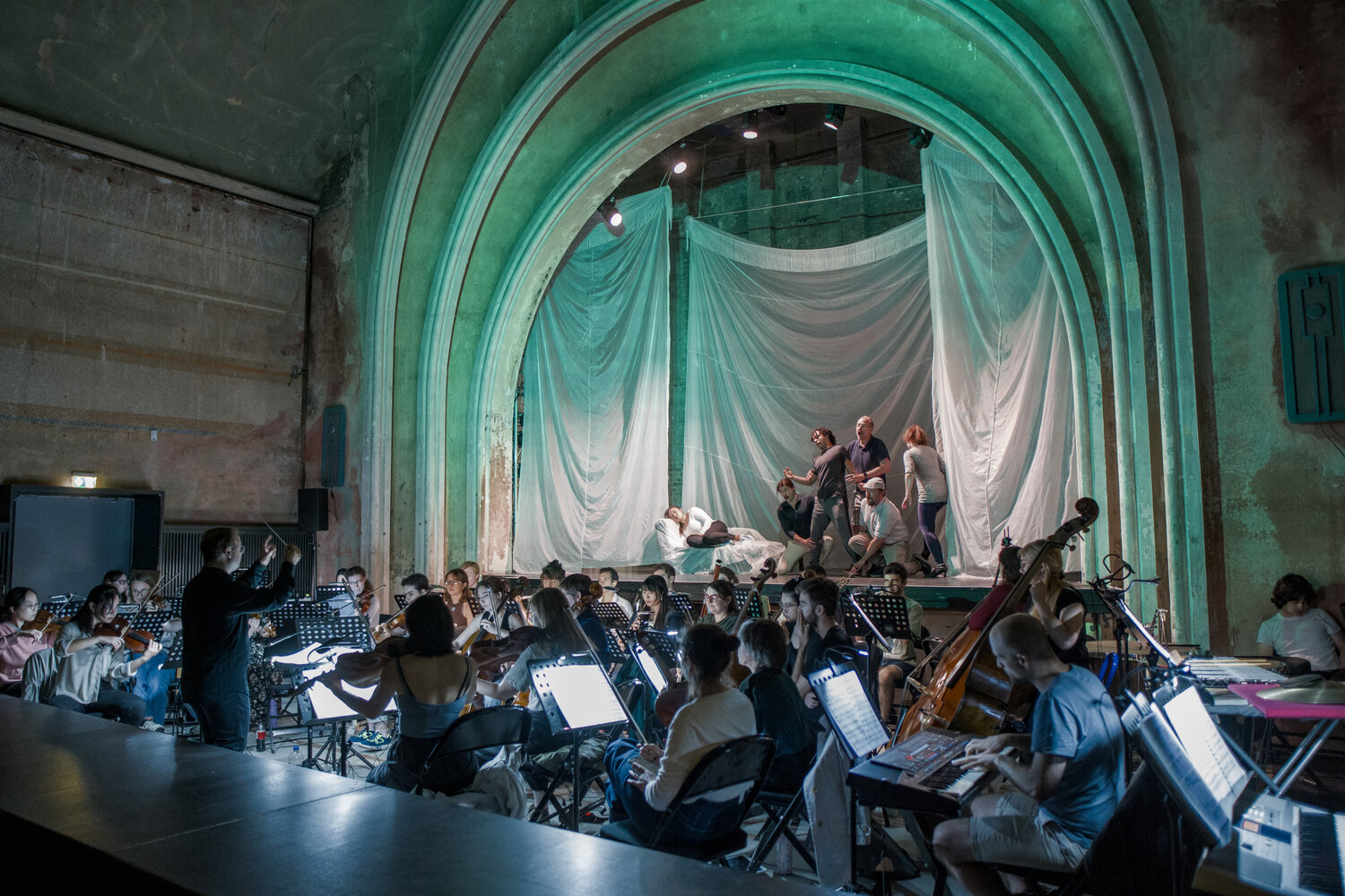 Opera rehearsal in theater with full orchestra